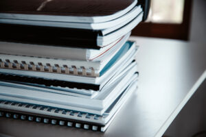Stack of reports lies on a desk ready for review
